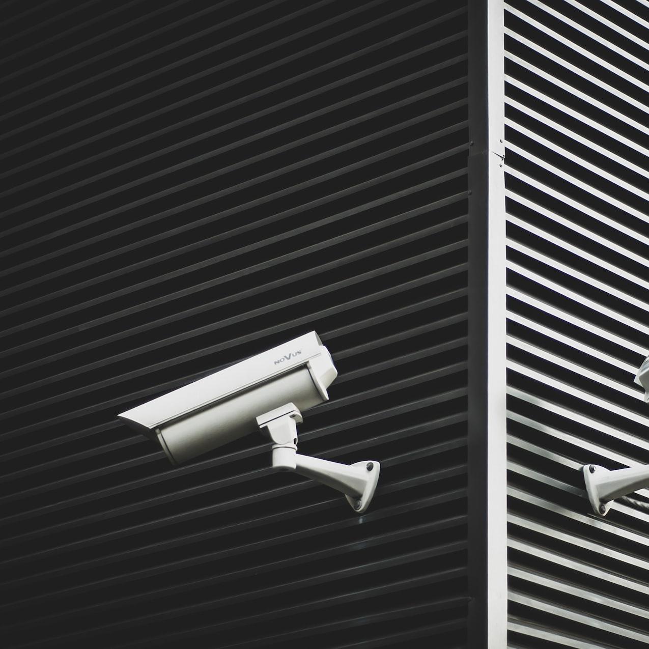 two grey CCTV cameras